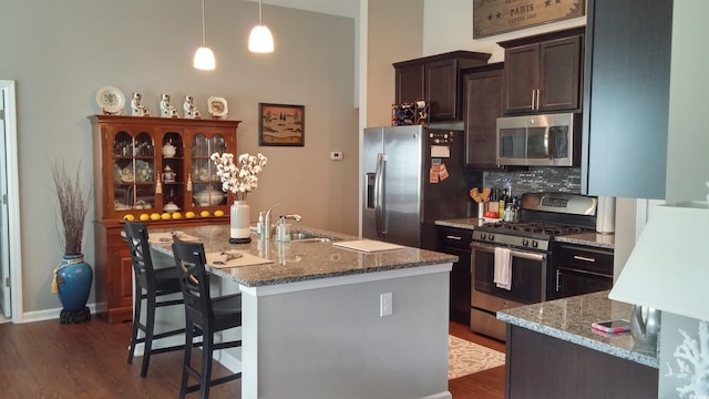 4463 Livorn Loop Unit 4463, Myrtle Beach, SC 29579 - kitchen featuring dark wood finished floors, a kitchen breakfast bar, dark brown cabinets, appliances with stainless steel finishes, and backsplash