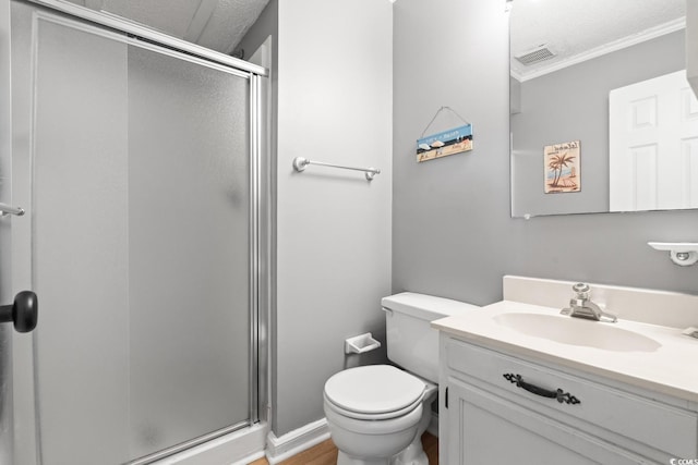 bathroom featuring a textured ceiling, vanity, ornamental molding, and a shower with shower door