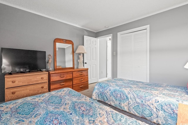 carpeted bedroom with a textured ceiling, a closet, and ornamental molding