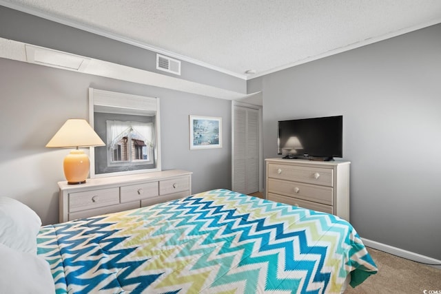 bedroom with carpet, crown molding, and a textured ceiling