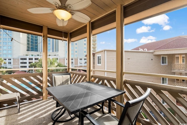 exterior space with ceiling fan and wood ceiling