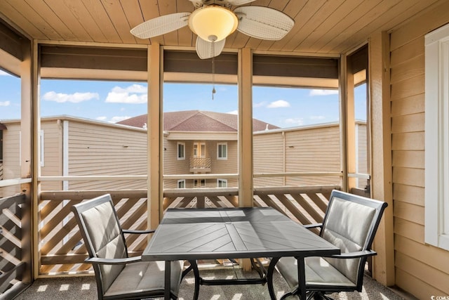 sunroom / solarium with wood ceiling, a wealth of natural light, and ceiling fan