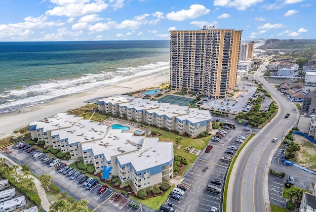 bird's eye view featuring a water view and a beach view