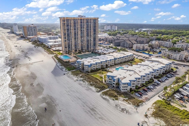 birds eye view of property with a view of the beach and a water view