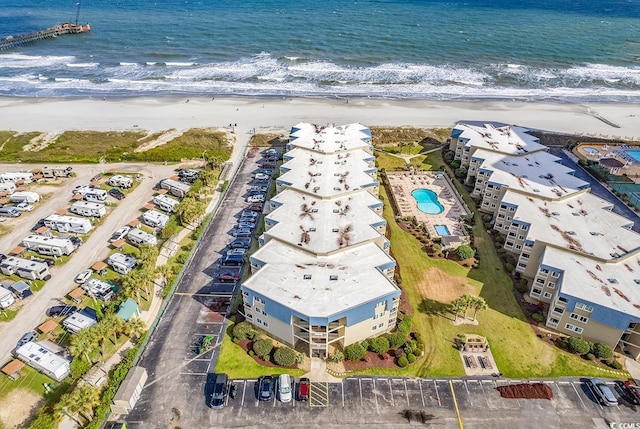 aerial view with a water view and a beach view