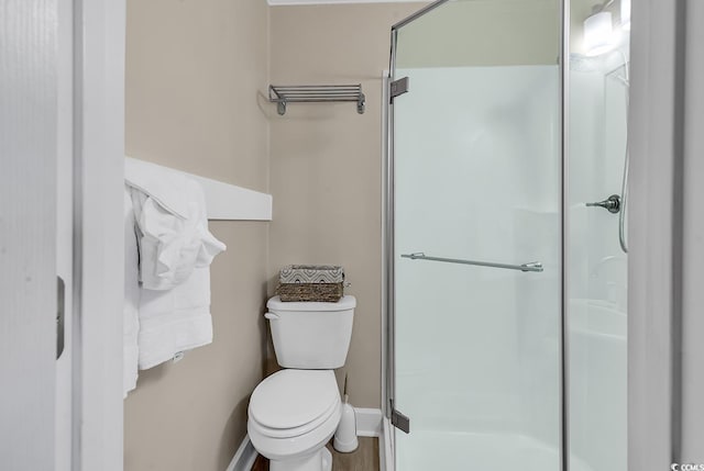 bathroom with toilet and walk in shower