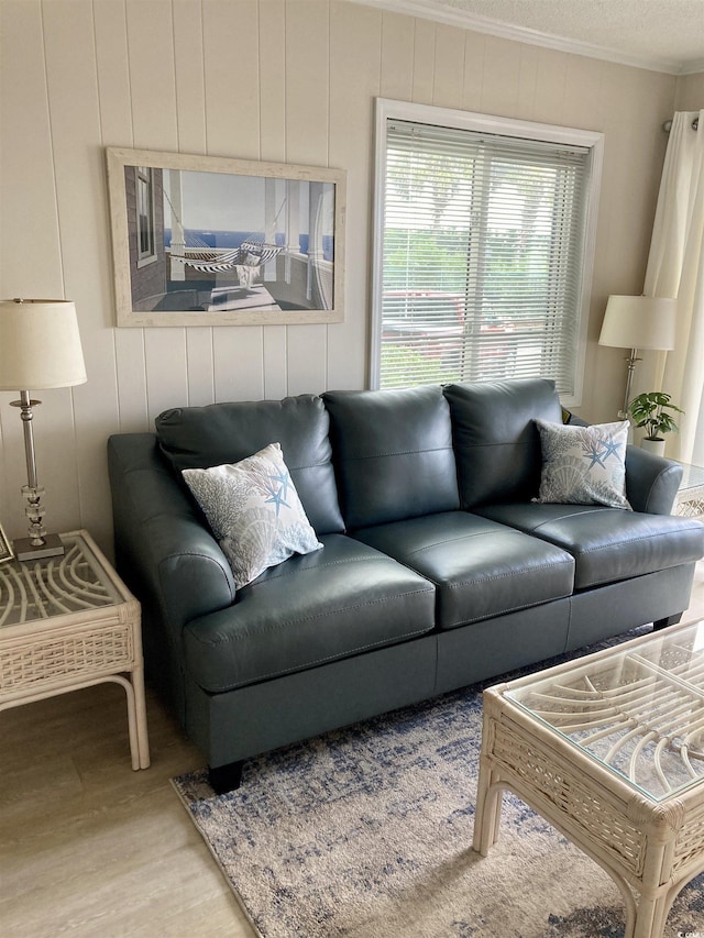 living room with hardwood / wood-style flooring and crown molding