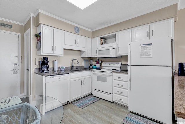 kitchen featuring light wood-type flooring, white appliances, a textured ceiling, sink, and white cabinets