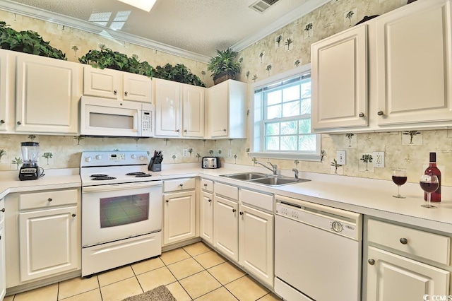 kitchen with white appliances, white cabinets, crown molding, sink, and light tile patterned flooring