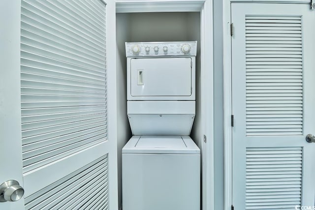 washroom featuring stacked washer and dryer