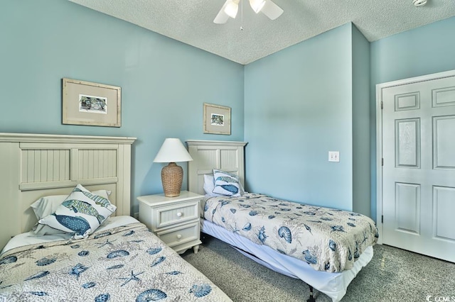 carpeted bedroom with ceiling fan and a textured ceiling