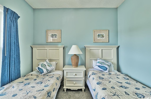 carpeted bedroom featuring a textured ceiling