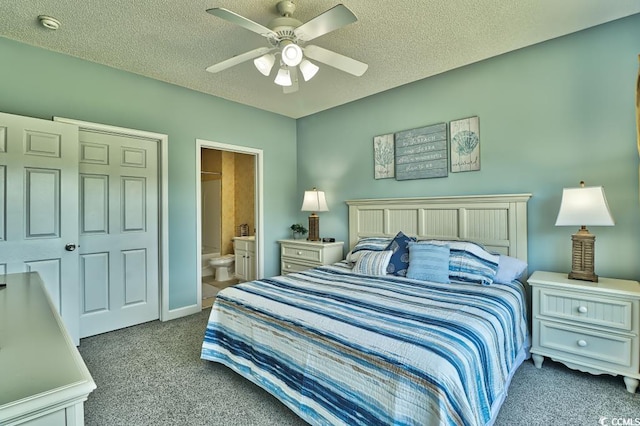 carpeted bedroom featuring ceiling fan, a textured ceiling, and ensuite bath