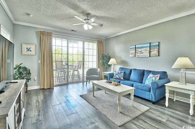 living room with a wealth of natural light, dark hardwood / wood-style flooring, ceiling fan, and ornamental molding