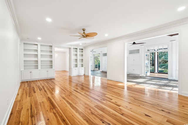 unfurnished living room featuring light wood-style floors, crown molding, and a ceiling fan