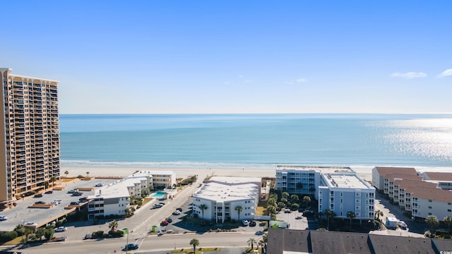 bird's eye view featuring a water view and a beach view