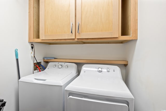 laundry area with cabinets and independent washer and dryer