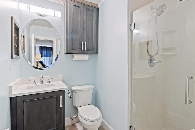 bathroom featuring vanity, toilet, walk in shower, and crown molding