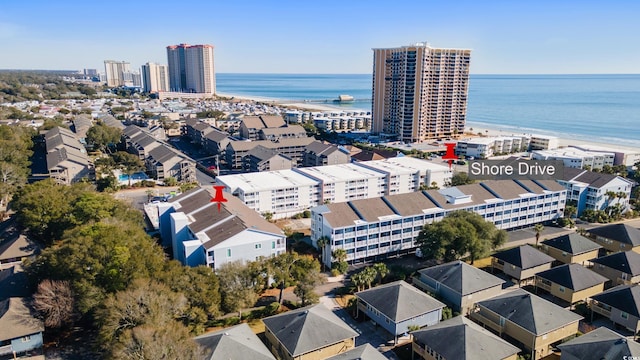 drone / aerial view featuring a beach view and a water view