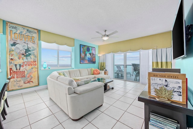 tiled living room with a textured ceiling and ceiling fan