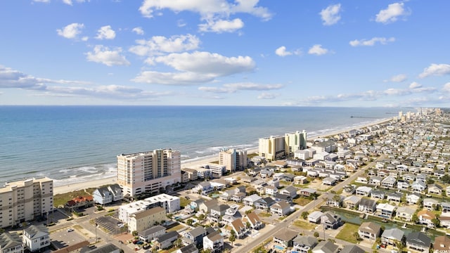 drone / aerial view featuring a water view and a beach view