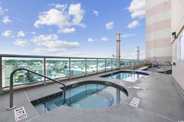 view of pool with a community hot tub