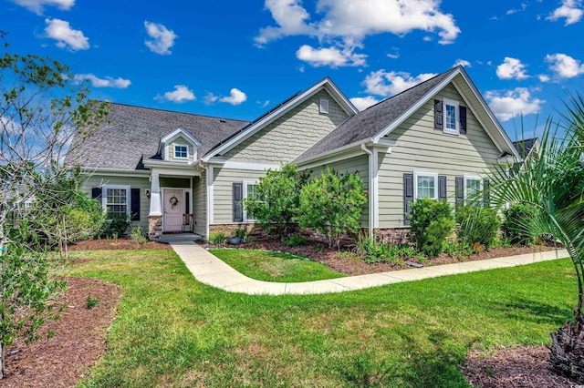 craftsman inspired home with a front lawn