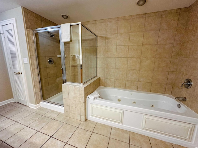 bathroom with tile patterned floors and shower with separate bathtub