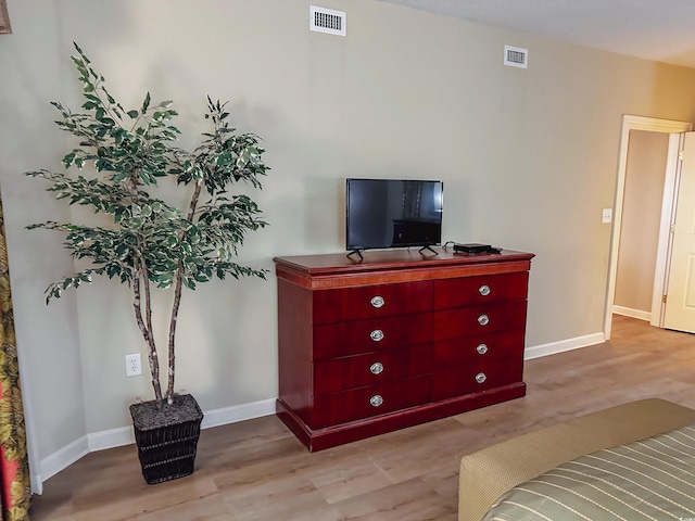 bedroom with light hardwood / wood-style floors