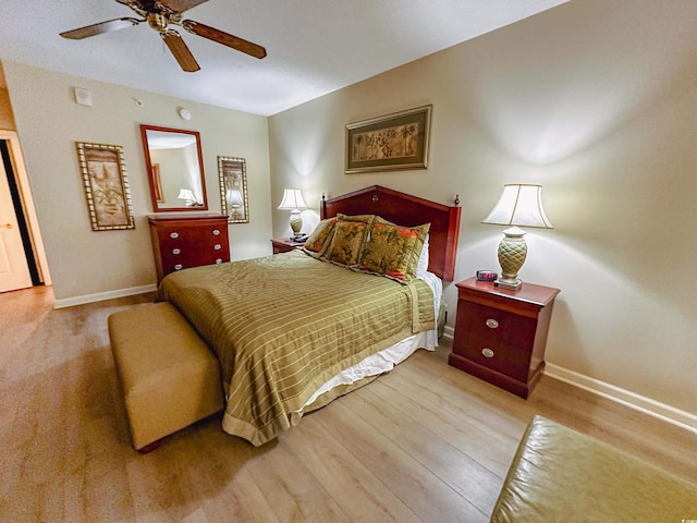 bedroom with light hardwood / wood-style floors and ceiling fan