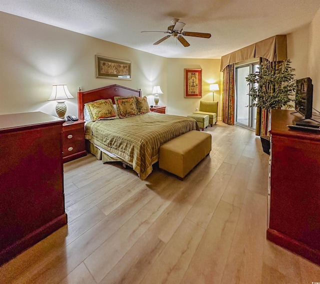 bedroom featuring access to exterior, ceiling fan, a textured ceiling, and light wood-type flooring