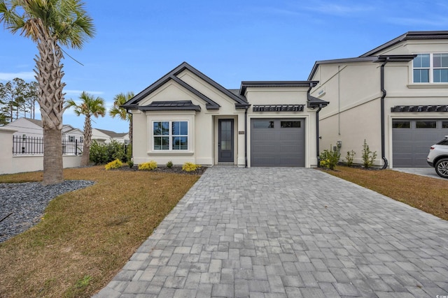 view of front of home with a garage and a front lawn