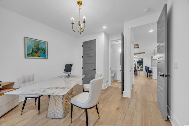 office area with a notable chandelier and light wood-type flooring