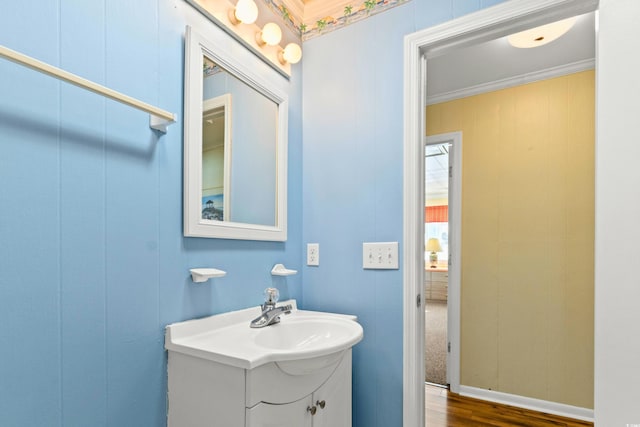 431 28th St S, Sunset Beach, NC 28468 - bathroom featuring crown molding, vanity, and wood-type flooring