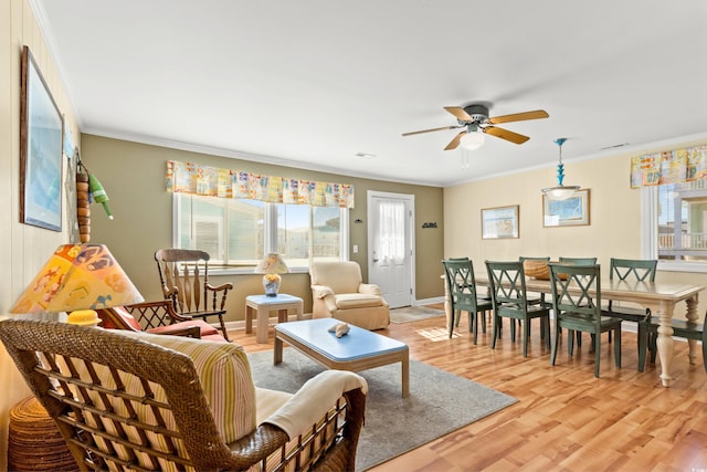 431 28th St S, Sunset Beach, NC 28468 - living room featuring ceiling fan, light hardwood / wood-style floors, and ornamental molding