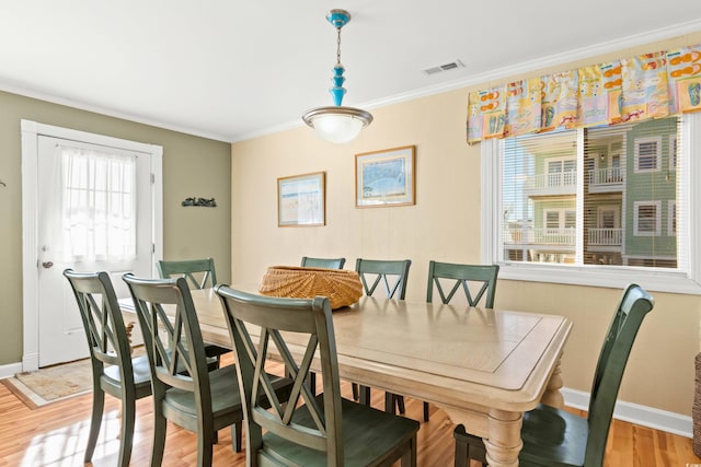 431 28th St S, Sunset Beach, NC 28468 - dining area featuring light hardwood / wood-style floors and crown molding