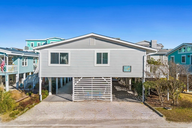 back of house with a carport