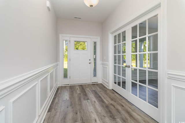 doorway with french doors and hardwood / wood-style flooring