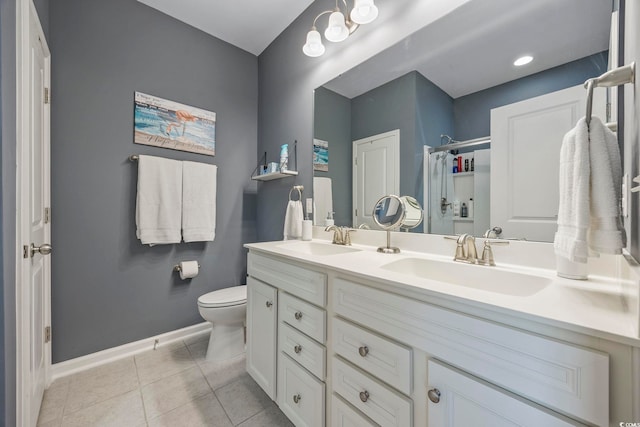 bathroom featuring tile patterned floors, vanity, toilet, and walk in shower