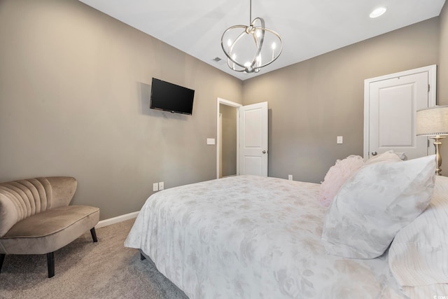 bedroom featuring light colored carpet and an inviting chandelier