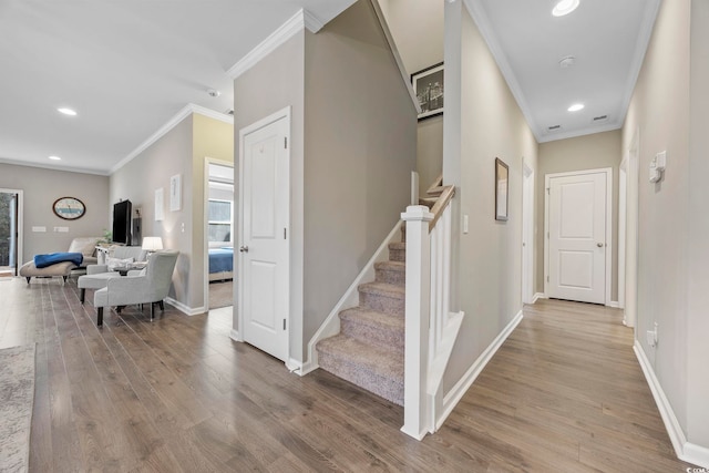 hall featuring light wood-type flooring and crown molding