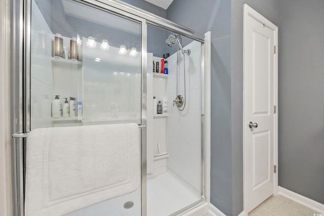 bathroom with tile patterned floors and an enclosed shower