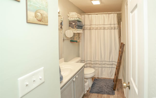 full bathroom featuring toilet, vanity, shower / tub combo, and hardwood / wood-style flooring