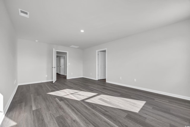 unfurnished room with dark wood-type flooring