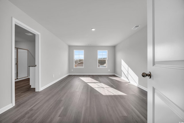 spare room with dark hardwood / wood-style floors