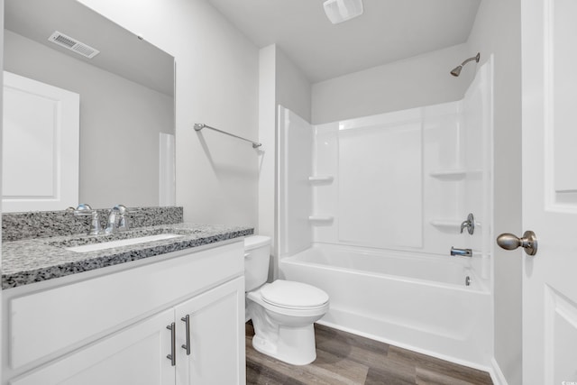 full bathroom featuring shower / tub combination, vanity, hardwood / wood-style flooring, and toilet