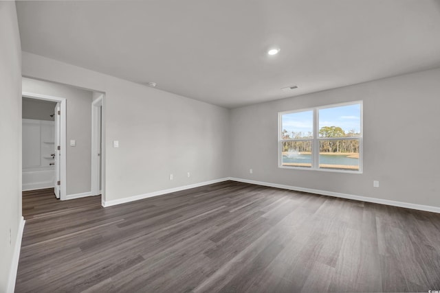 spare room featuring dark wood-type flooring