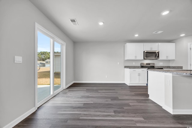 kitchen with white cabinetry, dark hardwood / wood-style flooring, and appliances with stainless steel finishes