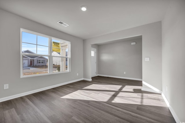 empty room with dark hardwood / wood-style floors