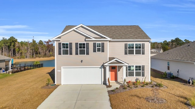 view of front of house featuring a front yard, a garage, and central AC unit